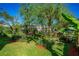 Secluded backyard oasis boasting lush green lawn, mature trees, and a private ambiance perfect for relaxation and outdoor enjoyment at 1613 Crescent Ridge Rd, Daytona Beach, FL 32118