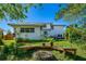 Spacious backyard featuring a fire pit, mature trees, and a well-maintained lawn offering an ideal setting for outdoor gatherings at 1613 Crescent Ridge Rd, Daytona Beach, FL 32118
