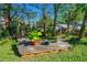 Charming backyard showcasing a unique deck, mature trees, and lush greenery offering a serene space for relaxation and enjoyment at 1613 Crescent Ridge Rd, Daytona Beach, FL 32118