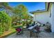 Inviting backyard features an outdoor dining area, a well-kept lawn, and mature trees providing a perfect setting for outdoor enjoyment at 1613 Crescent Ridge Rd, Daytona Beach, FL 32118