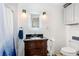 Bathroom with granite top vanity, modern lighting, toilet and shower with stylish shower curtain at 1613 Crescent Ridge Rd, Daytona Beach, FL 32118