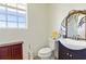 Bathroom with dark vanity, decorative mirror and tiled flooring at 1613 Crescent Ridge Rd, Daytona Beach, FL 32118