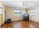 Bedroom with two windows, a ceiling fan, and hardwood floors at 1613 Crescent Ridge Rd, Daytona Beach, FL 32118
