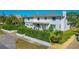 Inviting two-story home with a well-maintained exterior, lovely landscaping, and a pristine white color scheme on a sunny day at 1613 Crescent Ridge Rd, Daytona Beach, FL 32118