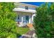 Charming two-story home with a quaint porch and lush greenery, creating a welcoming entrance at 1613 Crescent Ridge Rd, Daytona Beach, FL 32118