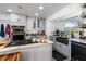 Well-lit kitchen featuring light gray cabinets, granite countertops, and a stainless steel gas range at 1613 Crescent Ridge Rd, Daytona Beach, FL 32118