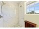 Walk-in shower with white marble style walls and a window for natural light at 1613 Crescent Ridge Rd, Daytona Beach, FL 32118