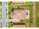 Overhead shot of a home highlighting the tile roof, brick patio, and lush landscaping with palm trees and green lawns at 163 Rosa Bella Vw, Debary, FL 32713