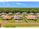 Beautiful aerial view of homes with lush green lawns, pristine landscaping and terra cotta roofs, set against a backdrop of dense trees at 163 Rosa Bella Vw, Debary, FL 32713