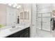 Bathroom with a white marble shower, black cabinets, and modern fixtures at 163 Rosa Bella Vw, Debary, FL 32713