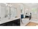 Elegant bathroom featuring a freestanding tub, double vanity, and glass-enclosed shower at 163 Rosa Bella Vw, Debary, FL 32713
