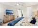Bedroom featuring a king bed, dresser with TV, and access to a hallway at 163 Rosa Bella Vw, Debary, FL 32713