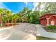 Inviting entrance drive, tropical foliage, palm trees, and well-maintained landscaping create a welcoming ambiance at 163 Rosa Bella Vw, Debary, FL 32713