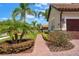 Landscaped walkway leading to a home's side entrance, showcasing lush planting beds and a tidy mulch bed at 163 Rosa Bella Vw, Debary, FL 32713