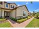 Exterior showcases a brick walkway leading to the home, complemented by tidy landscaping and attractive stone accents at 163 Rosa Bella Vw, Debary, FL 32713