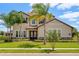 Charming two-story home with a tile roof, stone accents, mature landscaping, and a well-manicured lawn at 163 Rosa Bella Vw, Debary, FL 32713