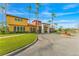 Elegant community clubhouse boasts palm trees, manicured lawn and a fountain, offering a resort-style ambiance at 163 Rosa Bella Vw, Debary, FL 32713