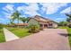 Spacious home with a tile roof, two-car garage, brick paver driveway, and meticulously manicured lawn at 163 Rosa Bella Vw, Debary, FL 32713