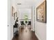 Hallway with hardwood floors leading to the upstairs landing at 163 Rosa Bella Vw, Debary, FL 32713