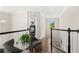 Upstairs landing with hardwood floors and seating area at 163 Rosa Bella Vw, Debary, FL 32713
