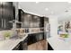 Modern kitchen with dark cabinets, white countertops, stainless steel appliances, and hardwood flooring at 163 Rosa Bella Vw, Debary, FL 32713