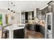 Spacious kitchen with dark cabinets, a white quartz island, stainless steel appliances, and hardwood flooring at 163 Rosa Bella Vw, Debary, FL 32713
