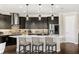 Modern kitchen featuring dark cabinets, a large island, stainless steel appliances, and stylish pendant lighting at 163 Rosa Bella Vw, Debary, FL 32713