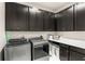 Laundry room with front load washer and dryer, plenty of dark cabinet space, and a white countertop at 163 Rosa Bella Vw, Debary, FL 32713