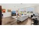 Spacious living room with hardwood floors, white sofa, and natural light at 163 Rosa Bella Vw, Debary, FL 32713