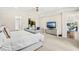 Serene main bedroom features tray ceiling and a view into the ensuite bathroom at 163 Rosa Bella Vw, Debary, FL 32713