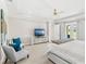 Light-filled main bedroom with carpet, tray ceiling, seating area, and doors to the patio at 163 Rosa Bella Vw, Debary, FL 32713