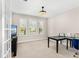 Well-lit home office with neutral walls, a black desk, and shuttered windows offering neighborhood views at 163 Rosa Bella Vw, Debary, FL 32713