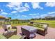 Inviting patio area with comfortable seating, offering a relaxing outdoor space with views of the surrounding neighborhood at 163 Rosa Bella Vw, Debary, FL 32713