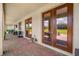 Covered patio with brick flooring, outdoor furniture, and a grilling area at 163 Rosa Bella Vw, Debary, FL 32713