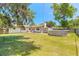 Beautiful backyard featuring a well-maintained lawn, above-ground pool, and mature trees for shade at 1650 Jacobs Rd, South Daytona, FL 32119