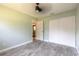 Bedroom with wood-look tile flooring, closet, neutral paint and a ceiling fan at 1650 Jacobs Rd, South Daytona, FL 32119