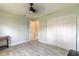 Bedroom featuring new gray flooring, light green paint and a ceiling fan at 1650 Jacobs Rd, South Daytona, FL 32119