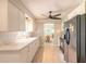 Bright kitchen featuring white cabinets, modern appliances, and tile floors at 1650 Jacobs Rd, South Daytona, FL 32119