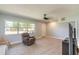 Inviting living room with neutral tones, tile flooring, ceiling fan, and comfortable armchair near a window at 1650 Jacobs Rd, South Daytona, FL 32119
