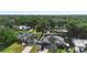 Aerial photo capturing the house in a neighborhood with mature trees and well-kept lawns at 1715 Queen Palm Dr, Edgewater, FL 32132