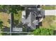 Birds-eye view of the home showcasing the roof, driveway, and surrounding green landscape at 1715 Queen Palm Dr, Edgewater, FL 32132