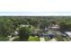 Aerial view of the property showing its location in a lush, green neighborhood at 1715 Queen Palm Dr, Edgewater, FL 32132