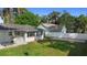 Picture of a spacious, fenced-in backyard with a sunroom and well-manicured lawn at 1715 Queen Palm Dr, Edgewater, FL 32132