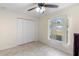 Bright bedroom with a ceiling fan, a large window, and tiled floor at 1715 Queen Palm Dr, Edgewater, FL 32132