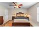 Cozy bedroom with ceiling fan, and matching nightstands with lamps at 1715 Queen Palm Dr, Edgewater, FL 32132