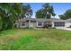 Charming single-story home features a well-maintained lawn and a screened garage at 1715 Queen Palm Dr, Edgewater, FL 32132