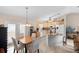 Bright kitchen and dining area with island, tile floors, modern appliances, and stylish lighting at 1715 Queen Palm Dr, Edgewater, FL 32132