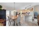 Dining area adjacent to an open kitchen with granite island, neutral cabinets, and tile flooring at 1715 Queen Palm Dr, Edgewater, FL 32132