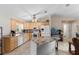 Bright kitchen featuring an island with granite countertop, tile floors, and modern appliances at 1715 Queen Palm Dr, Edgewater, FL 32132