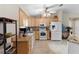 Bright kitchen featuring tile floor, modern appliances, and wood cabinets with light countertops at 1715 Queen Palm Dr, Edgewater, FL 32132